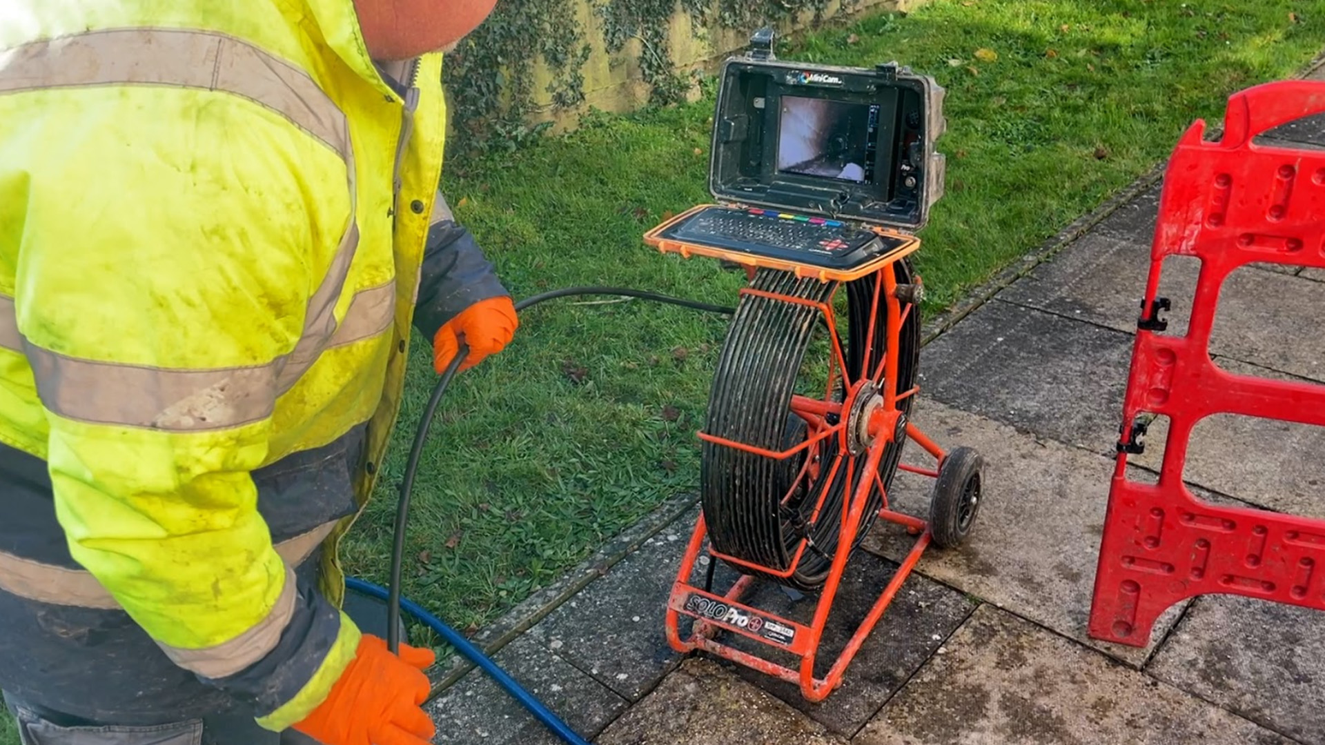 Engineer operating a CCTV drain camera rig